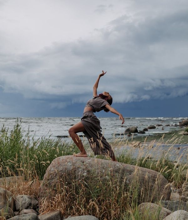 Person moving gracefully, captured in a moment of fluid motion.